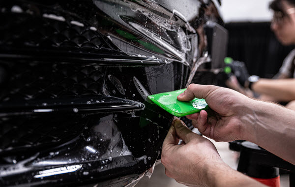 Worker Applying Paint Protection Film